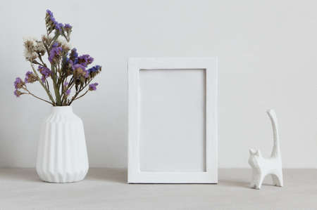 White mockup frame with vase and cat statuette.の写真素材