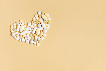 Pills in the shape of a heart. The concept of cardiac drugs with copy spaceの写真素材