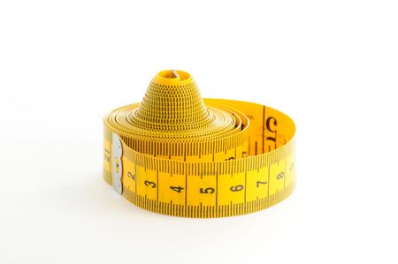 Roll of yellow measuring tape over white backgroundの写真素材