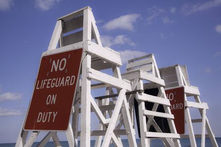 Empty lifeguard tower chair with not on duty signの写真素材