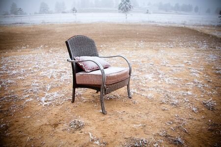 Vintage chair ona morning frost after a night of snowの写真素材