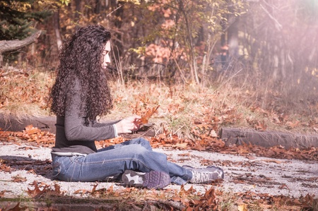 Beautiful woman enjoyin the utsoor nature during a colorful autum fall day