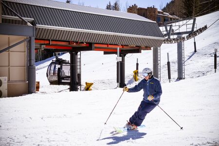 ASPEN, USA, FEBRUARY, 13th 2015: SkIers and lift during ski season in Aspen, Coloradoのeditorial素材