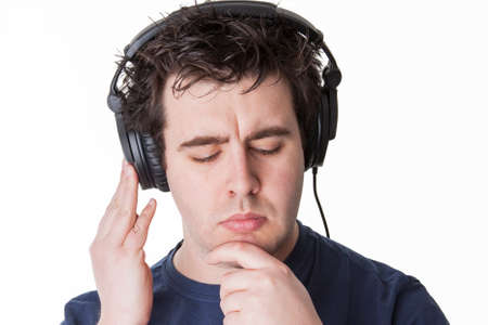 man thinks about the next music track which would fit best to his lifestyleの写真素材