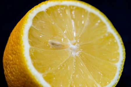 Yellow lemon citrus isolated on a black backgroundの写真素材