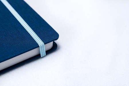 Blue notebook and a Pen isolated on a white background for businessの写真素材
