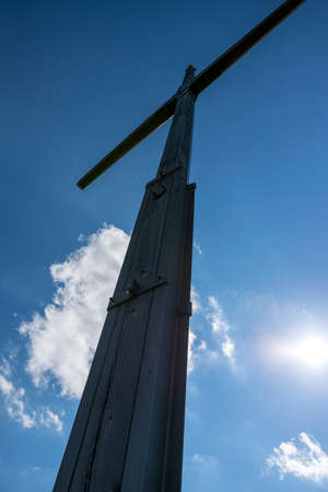 Summit Cross on the top of a mountain with clouds in the sky in the bavarian forestの写真素材