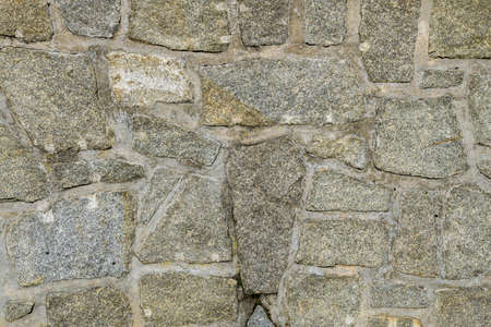 Granite wall with structure and joints as a texture and backgroundの写真素材