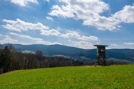 Hunter seat with clouds and fields in the bavarian forestの写真素材