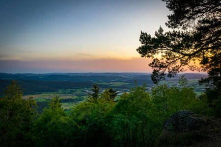 Sunset on top of a mountain in the bavarian forestの写真素材