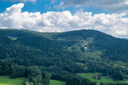 View in a valley from top of a mountain on a sunny day in the bavarian forestの写真素材