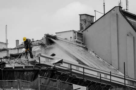 Construction worker on top of a house