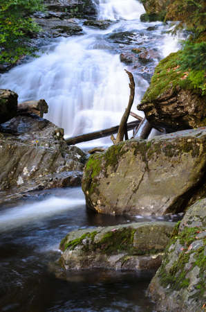 Waterfall and a Creek with green Moss in the bavarian forest with great stones in front ofの写真素材