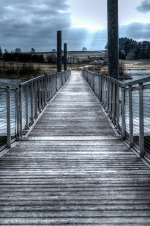 Footbridge over a lake in the bavarian forestの写真素材