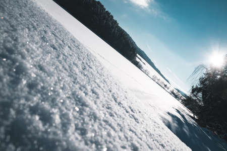 Frozen Lake with sun on the sky in the winter in the bavarian forestの写真素材