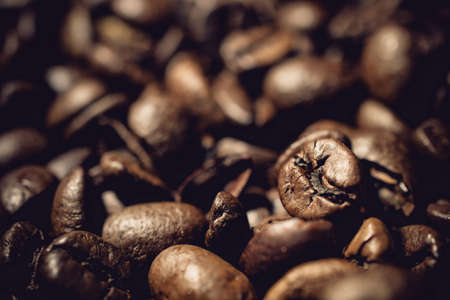 Coffea beans as a closeup with a lot of brown roasted beansの写真素材
