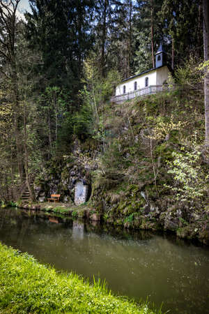 Small Chapel on a hill with a river in front of in the bavarian forestの写真素材