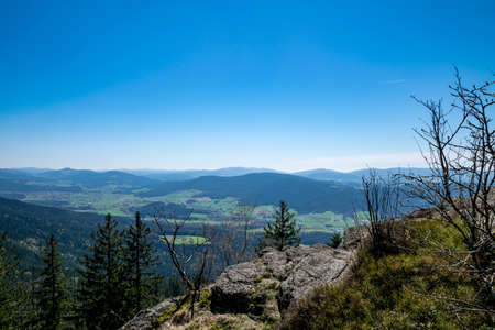 View in a valley from top of a mountain on a sunny day in the bavarian forestの写真素材
