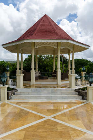 Pavillion with clouds on the sky and reflections on the groundの写真素材