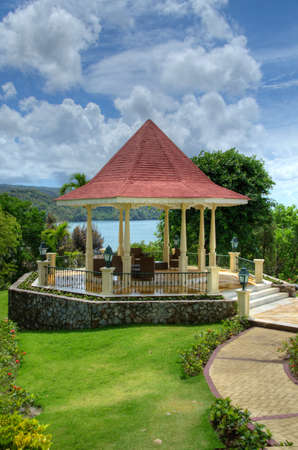 Small pavillion with clouds on the sky and ocean behindの写真素材