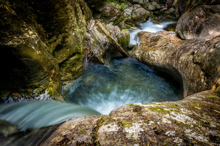 Waterfall with rocks and stones in the green nature in the bavarian forestの写真素材