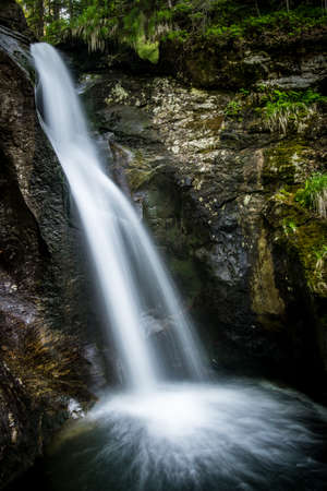 Waterfall with rocks and stones in the green nature in the bavarian forestの写真素材