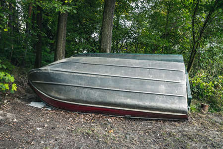 Boat in front of trees near a lakeの写真素材