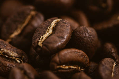 Coffee beans roasted on a wooden table with much of beans with a great aromaの写真素材