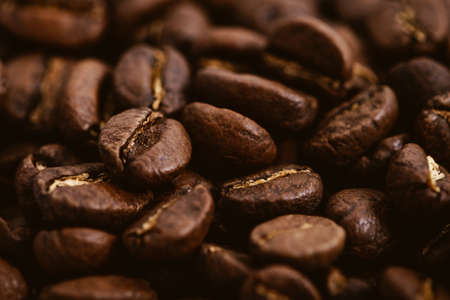 Coffee beans roasted on a wooden table with much of beans with a great aromaの写真素材