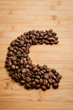 Coffee beans roasted on a wooden table with much of beans with a great aromaの写真素材