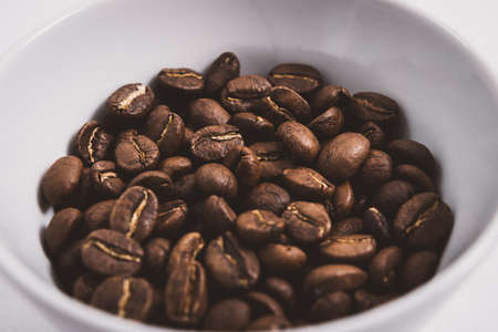 Coffee beans roasted on a wooden table with much of beans with a great aromaの写真素材