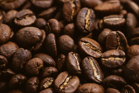 Coffee beans roasted on a wooden table with much of beans with a great aromaの写真素材