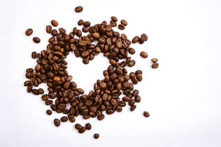 Heart with fresh roasted coffee beans on a white background with a great aromaの写真素材