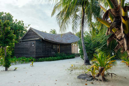 Bungalows and houses in the Maldives with beautiful turquoise sea and clouds in the skyの写真素材