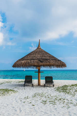 Lying on the white sandy beach of the Maldives overlooking the turquoise seaの写真素材