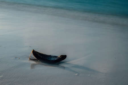 Half of a coconut at the white beach at the maldives