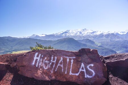 A stone with handwritten letters facing the High Atlas mountains in Maroccoの写真素材