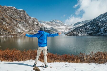 A boy enjoying the view to Tsomgo Lake in North Sikkim. Just above the mountains is Tibet.の写真素材
