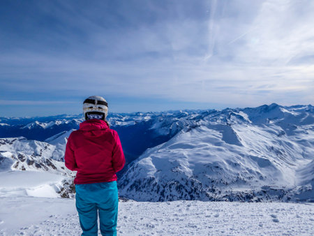 Snowboarding girl standing on the top of a mountain in Moelltaler Gletscher, Austria, enjoying the...