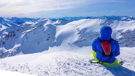 Skiing young man sitting on the snow in Moelltaler Gletscher, Austria, enjoying the view. Lots of...