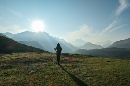 A man enjoying an early morning in Italian Dolomites. The valley below is shrouded in morning haze....