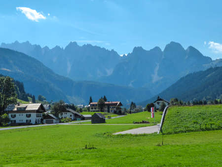 A panoramic view on the distant, high Alpine chains in the region of Gosau, Austria. There is a...