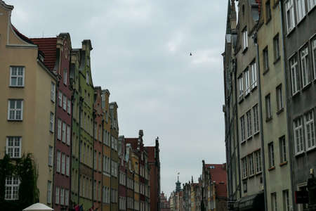 A deserted street in Old Town of Gdansk, Poland. The both sides of a paved alley have tall medieval...