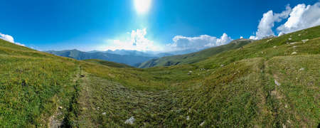 A panoramic view on high Caucasus mountains in Georgia. There are high, snowcapped peaks in the...