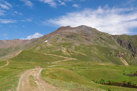 Dirt road leading to the Koruldi Lakes with an amazing view on the highlands and hills near Mestia...