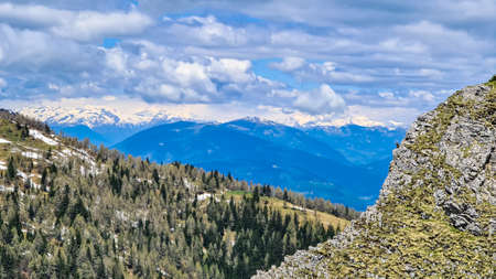 Mountain peak of Hahnkogel (Klek) with panoramic view in spring in the Karawanks, Carinthia, Austria. Borders Austria, Slovenia, Italy. Triglav National Park. Alpine meadows. Alm. Snow fields meltingの写真素材