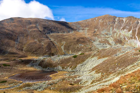 Scenic view on lake Goldlacke and Haemerkogel in the Lower Tauern mountain range, Styria, Austria, Europe. Sunny autumn day in Seckau Alps. Scenic hiking trail to Seckauer Zinken on dry, bare terrainの写真素材