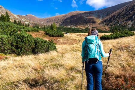 Woman with backpack on hiking trail leading to Seckauer Zinken in the Lower Tauern mountain range,...