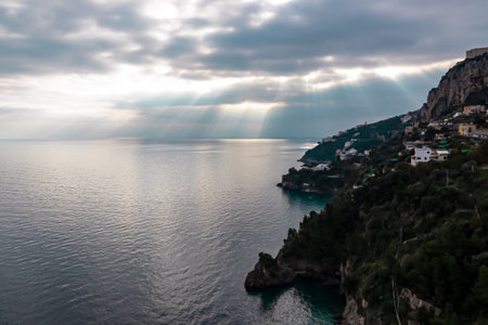 Panoramic sunset view on Amalfi Coast from the Path of the Gods (Sentiero Degli Dei) in Campania, Italy, Europe. Hiking trail from Praiano to Amalfi. Coastal town in the Province of Salerno. Overcastの写真素材