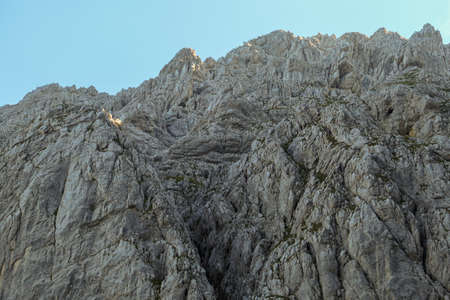A steep mountain wall on the way to Grimming in Austrian Alps. Dangerous climbing only for...